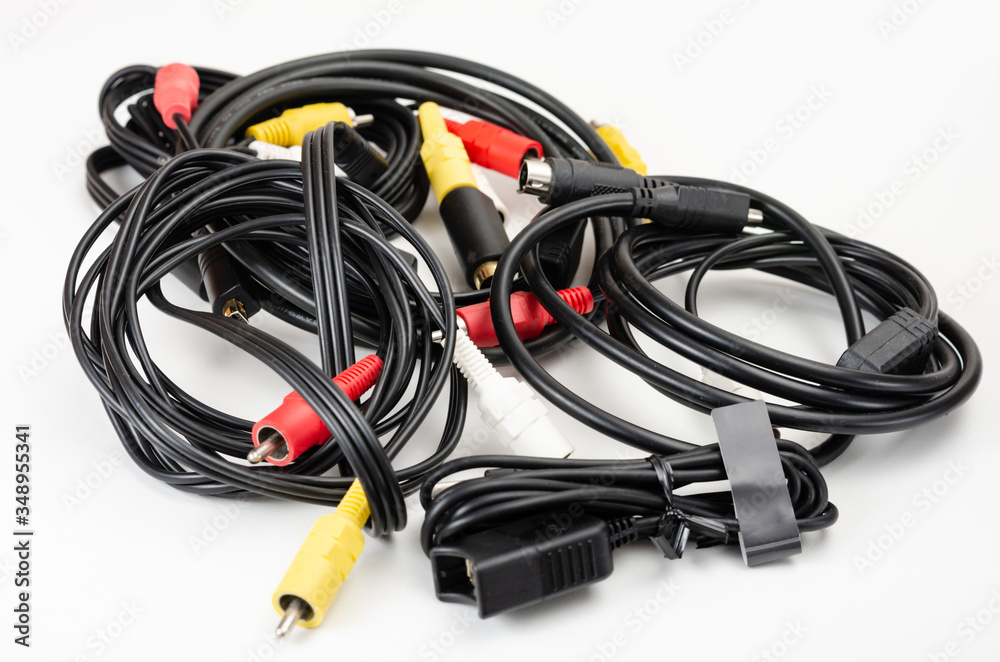 Close-up pile of analog rca cables for connection between camcorder, dvd player, blu-ray on white background. Close-up pile of analog rca cables for connection between camcorder, dvd player, blu-ray on white background.