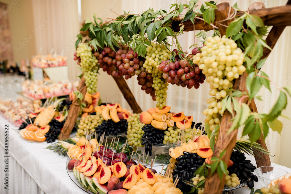 delicious fresh fruits on plate on table at wedding reception in restaurant. luxury catering