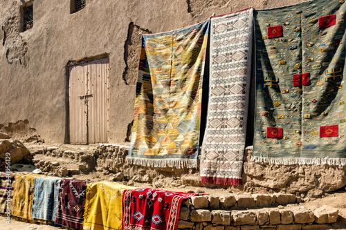 colorful handmade wool rugs at street market in Morocco	