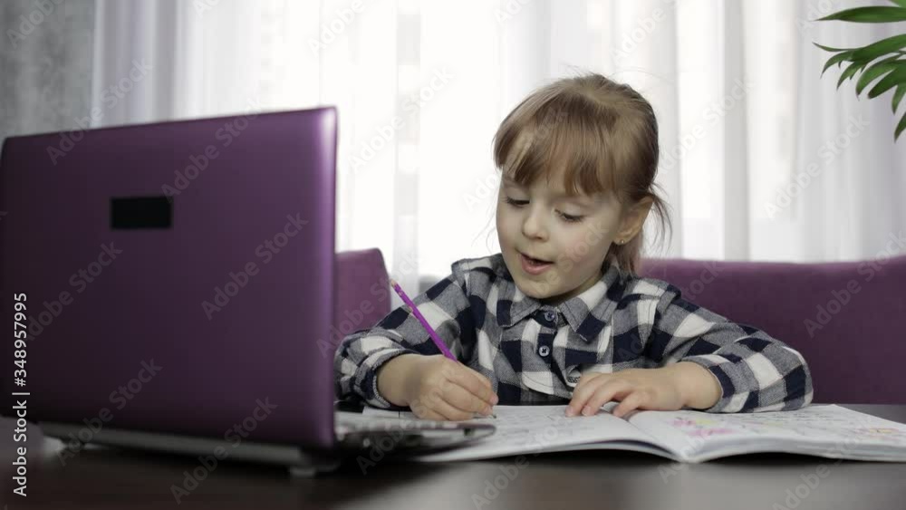 Girl studying online homework using digital laptop computer. Distance education Girl studying online homework using digital laptop computer. Distance education