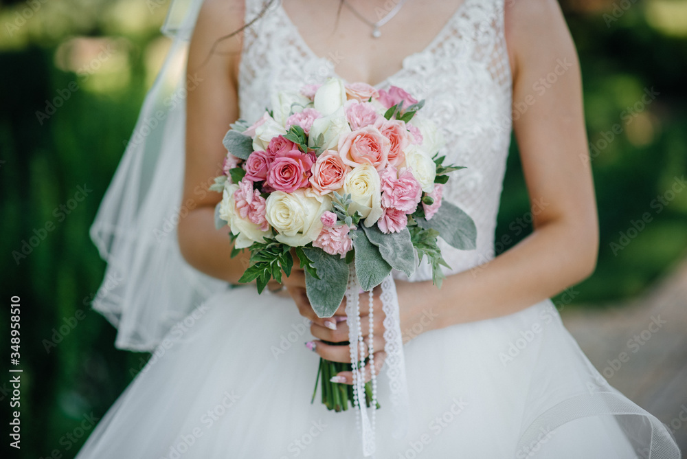 Beautiful and sophisticated wedding bouquet close-up holds the bride in her hands. Wedding bouquet