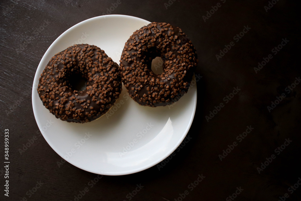 Chocolate donuts on a white plate Chocolate donuts on a white plate