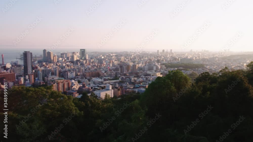 Beautiful light on this elevated cityscape of Kobe in Japan. Dense buildings with river or sea in distance Beautiful light on this elevated cityscape of Kobe in Japan. Dense buildings with river or sea in distance
