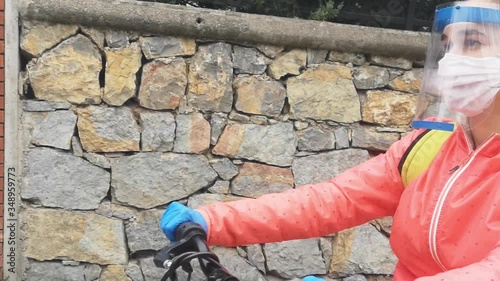 Young woman cycling with protective mask