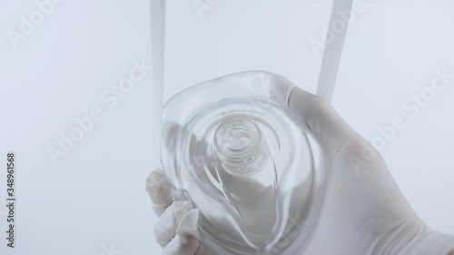 Putting on oxygen mask. White surgical gloves in sterile environment