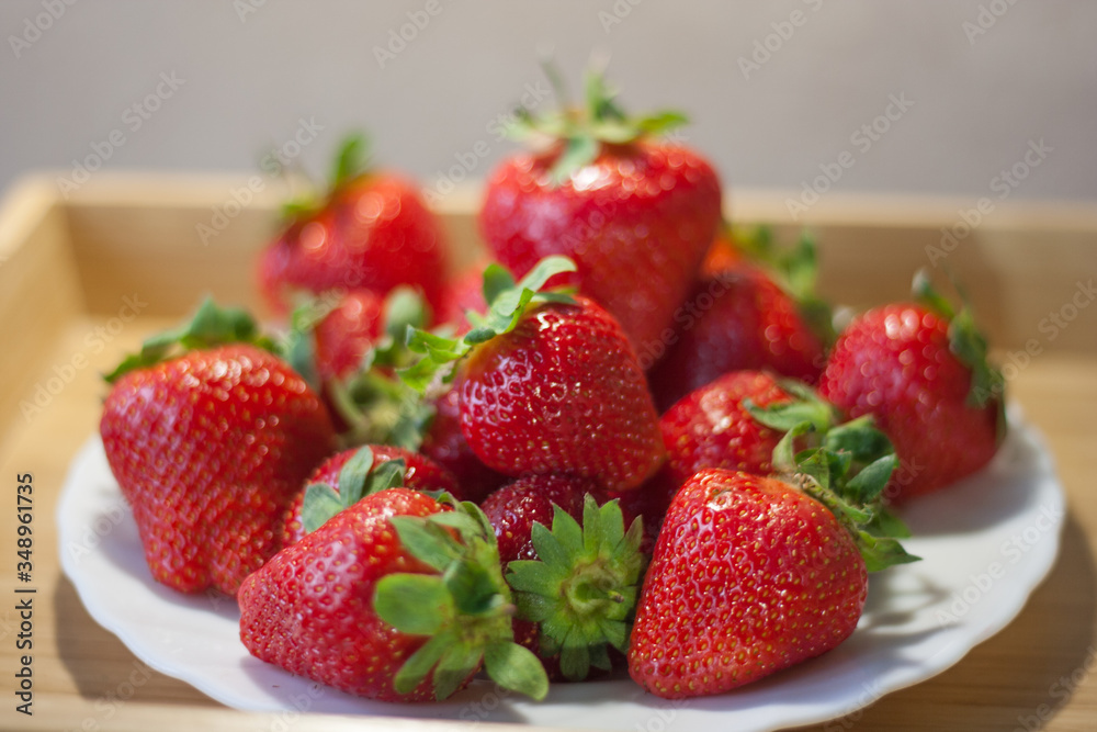 Fresh ripe strawberries in a white plate Fresh ripe strawberries in a white plate