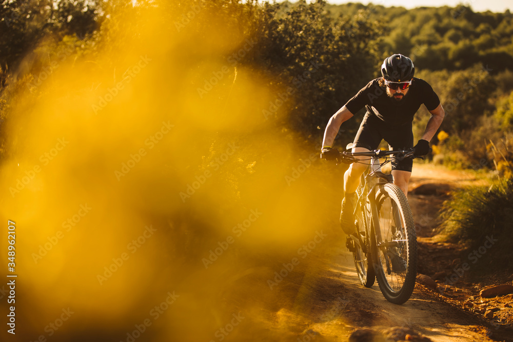 Naklejka premium Cyclist man riding mountain bike on a mountain.