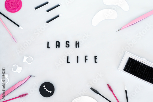Vászonkép A beauty background displaying eyelash extension products, tools and equipment in a flat lay style