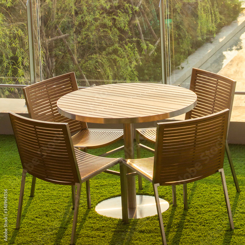 Empty Wooden Tea table on rooftop garden by swimming pool in the evening  , Square ration