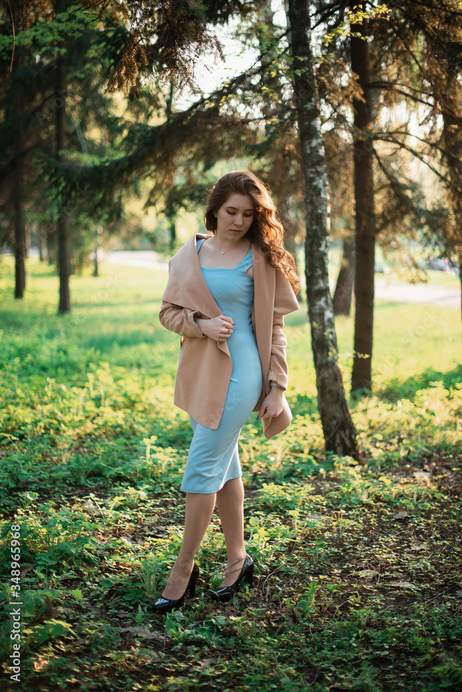 Beautiful young girl in a blue dress in a spring park Beautiful young girl in a blue dress in a spring park