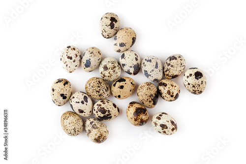 Quail eggs on a white background. Several quail eggs close-up on a white background. Top view.