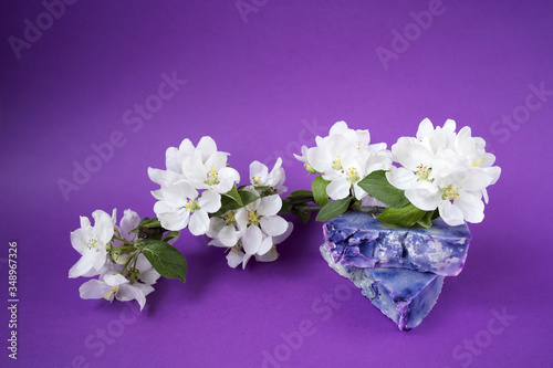 Hand made soaps on the purple background. White flowers on the natural cosmetic. Small business