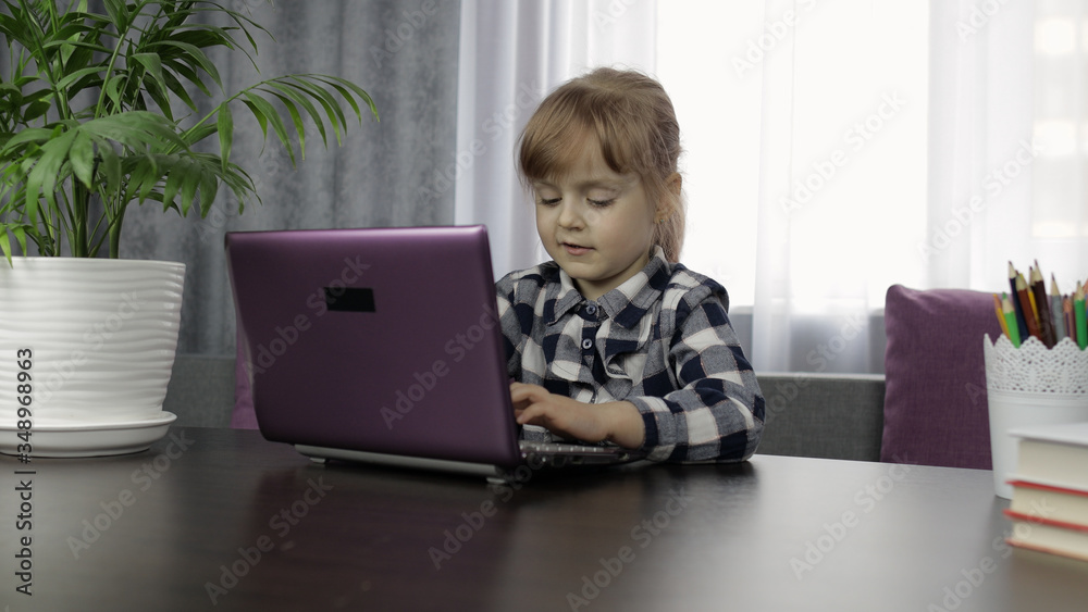 Girl studying online homework using digital laptop computer. Distance education Girl studying online homework using digital laptop computer. Distance education