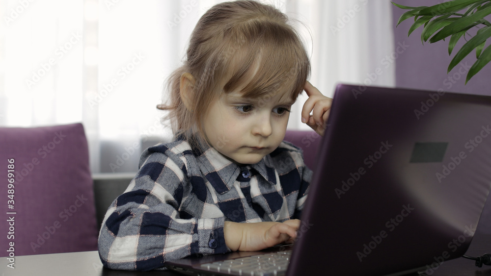 Girl doing online lessons using digital laptop computer. Distance education Girl doing online lessons using digital laptop computer. Distance education