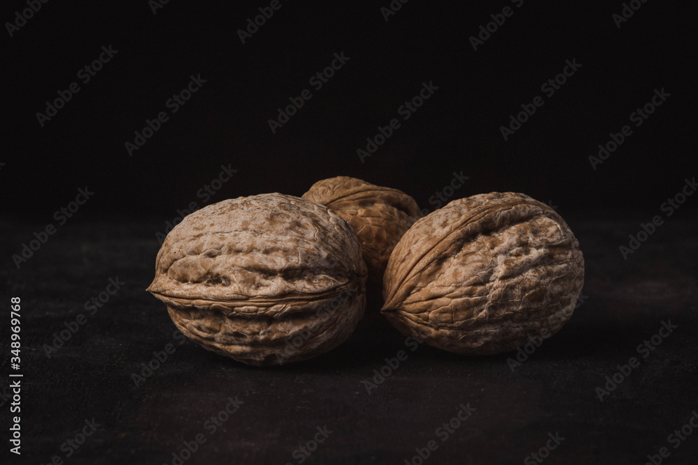 three nuts on a black background three nuts on a black background