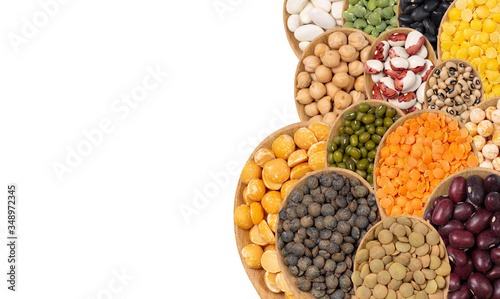 Wallpaper Mural Collection of legumes in wooden spoons on a white background top view. An isolated set of beans, lentils, peas, mung bean, chickpeas. Torontodigital.ca