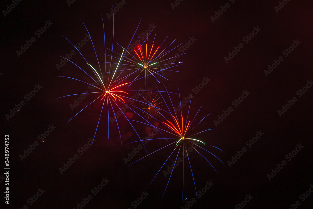 Blue, red and white fireworks against the backdrop of the night sky, Vittorio Veneto, Italy