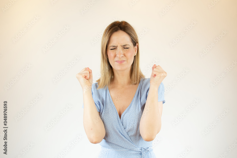 Beautiful woman doing victory gesture with arms Beautiful woman doing victory gesture with arms