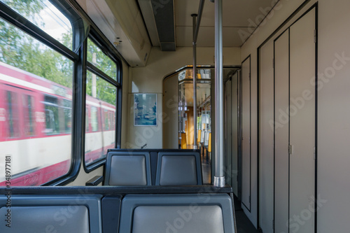 Interior view of a corridor inside passenger trains with old grey seats of German railway train system. Empty vacant passenger car inside the train. 