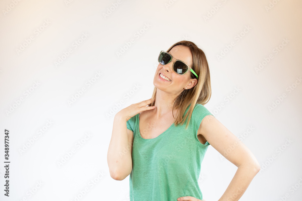 Beautiful woman laughing with glasses and green shirt Beautiful woman laughing with glasses and green shirt