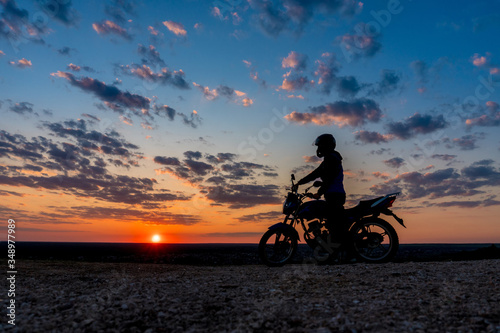 Motorcyclist enjoy at sunset sky 