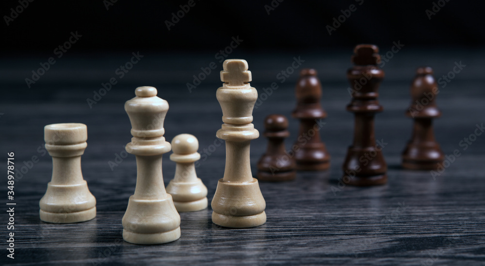 various chess pieces on a wooden background still life