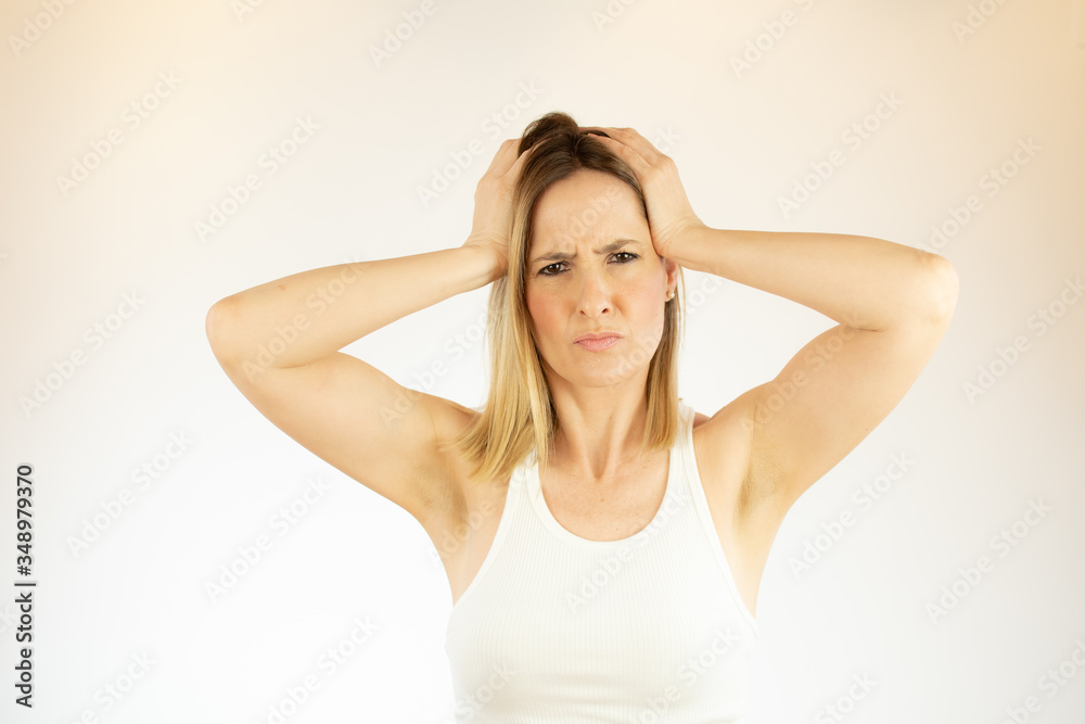 Pretty woman making a gesture with her hands on her head Pretty woman making a gesture with her hands on her head
