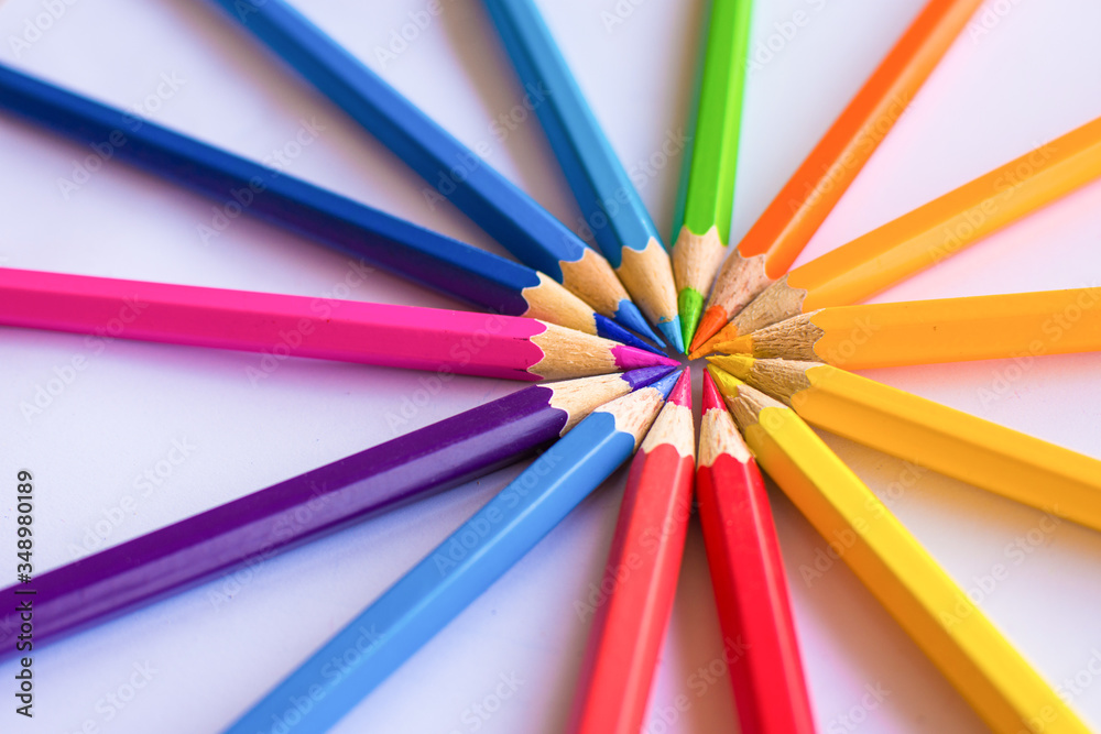 Different colored pencils, the pencil ends bump into circles on a white background Different colored pencils, the pencil ends bump into circles on a white background