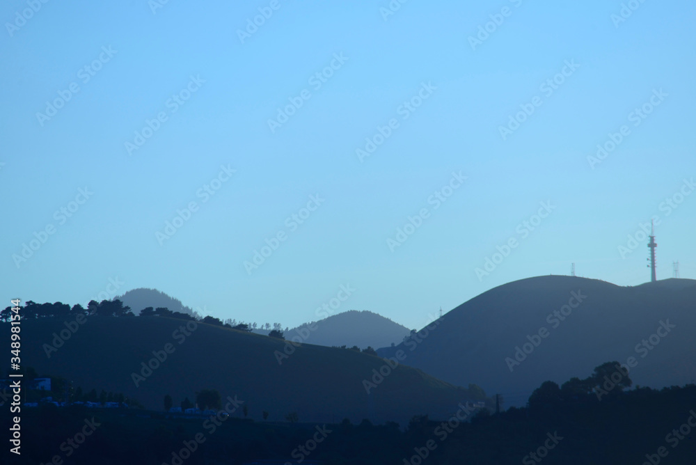 Hills under the blue light of dawn