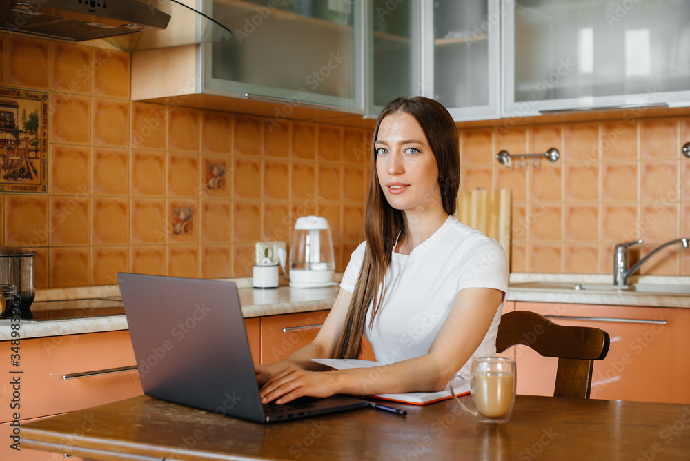 A young girl works at home on a remote site. Distance learning. Stay at home A young girl works at home on a remote site. Distance learning. Stay at home