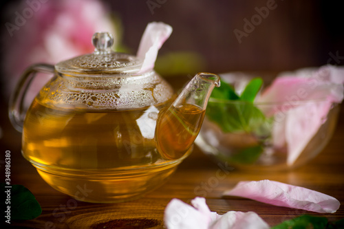 summer flower tea from rose petals in a glass teapot