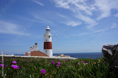 Lighthouse By Sea Against Blue Sky
