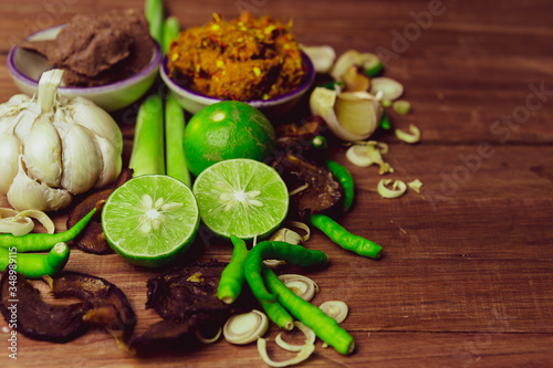 Spices and shrimp paste ready to cooking sour curry have chili garlic lemon grass lemon left side on wood table