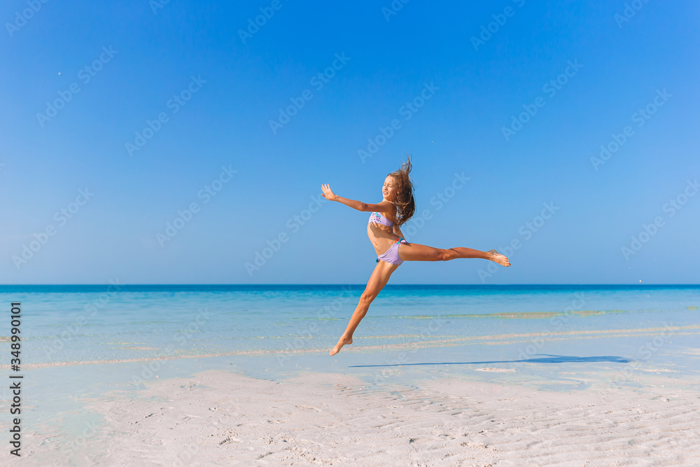 Adorable little girl have fun at tropical beach during vacation Adorable little girl have fun at tropical beach during vacation