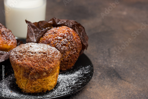 Freshly baked muffins with cacao, cinnamon and oat crumble topping on a natural wooden board
