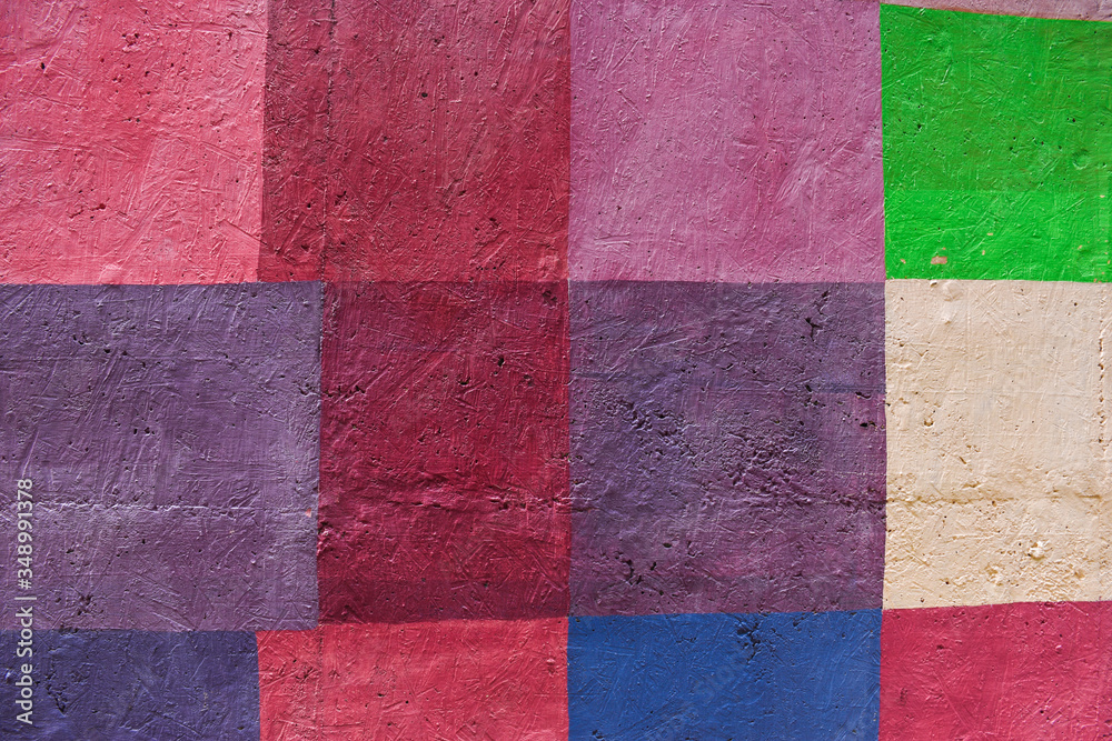 Concrete painted wall; square abstract background in red, pink, violet and green colors Concrete painted wall; square abstract background in red, pink, violet and green colors