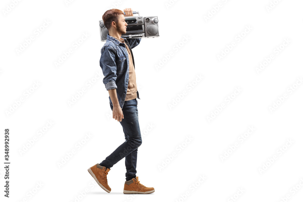 Guy walking and carrying a boom box radio on his shoulder - obrazy, fototapety, plakaty 