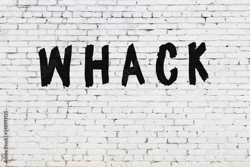 Obraz na plátně White wall with black paint inscription whack on it