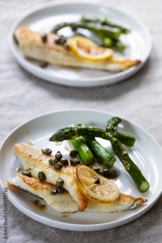 Lemon sole with butter and capers sauce and asparagus