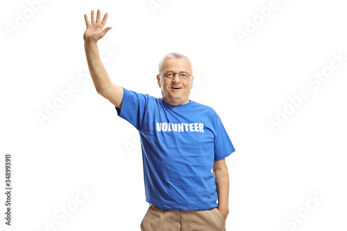 Elderly male volunteer waving