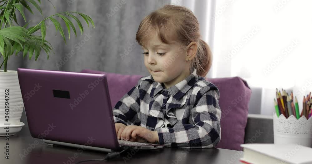 Girl studying online homework using digital laptop computer. Distance education Girl studying online homework using digital laptop computer. Distance education