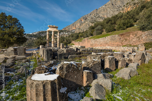 Ruins of Athena pronaia temple in Delphi with snow