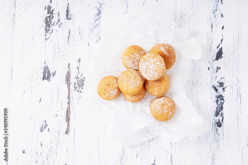 Fresh fried mini donuts sprinkled with powdered sugar