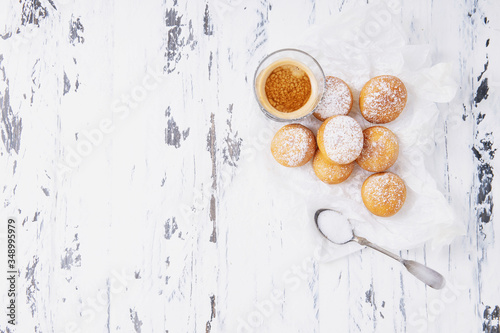 Fresh fried mini donuts sprinkled with powdered sugar
