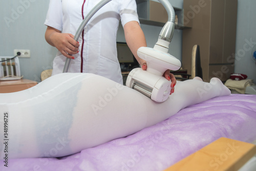 modern method for massage and cellulite removal on the girl's feet