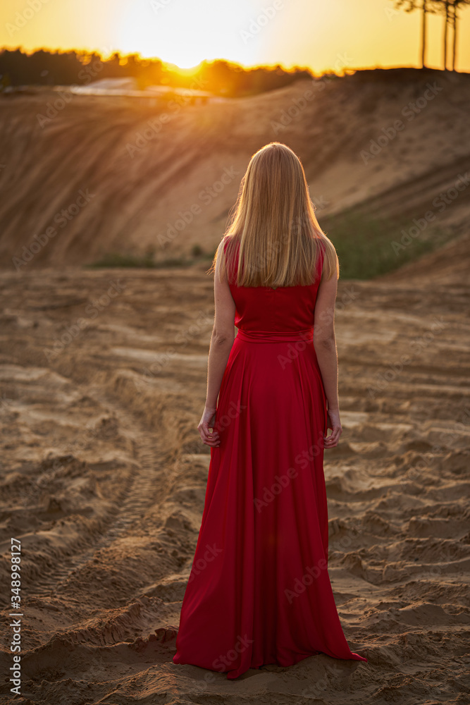 Beautiful fashion girl among the sands at sunrise Beautiful fashion girl among the sands at sunrise