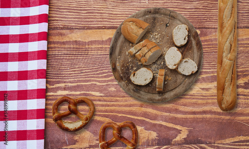 mixed bread and baguettes and pretzels on a wooden table