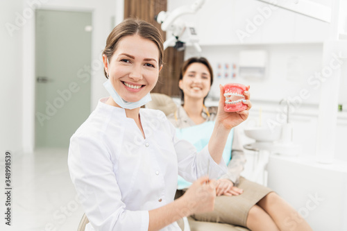 Female Dentist with denture in the dentistry's office