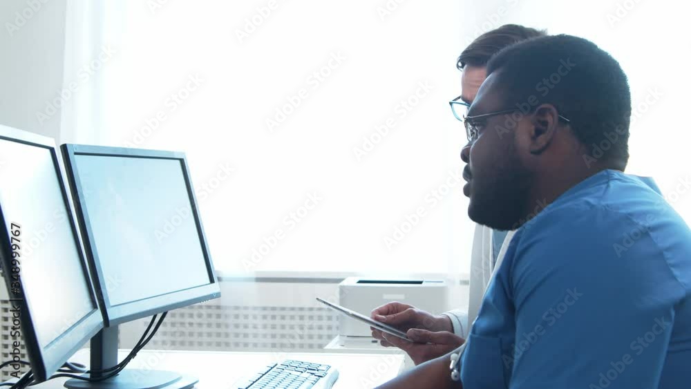Doctor and surgeon talking near window. Medical workers in hospital office. Day light. Healthcare, medicine, teamwork. Doctor and surgeon talking near window. Medical workers in hospital office. Day light. Healthcare, medicine, teamwork.
