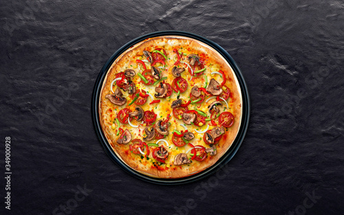 pizza in a pan on a black background